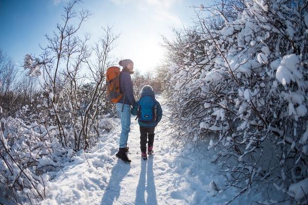 Kid and Parent Hiking in Winter